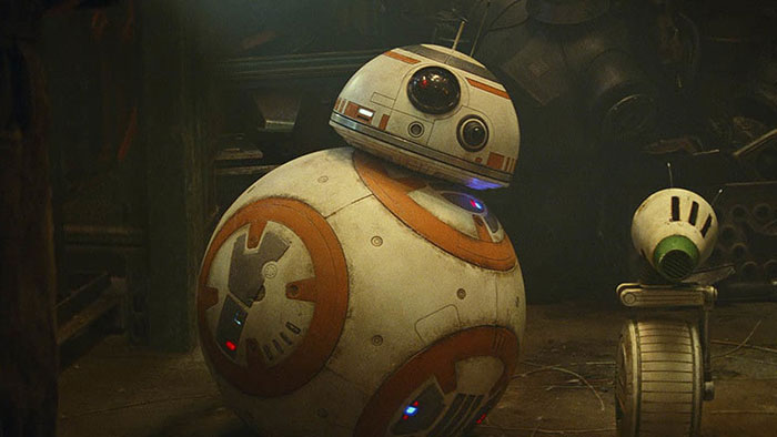 Cute animated character BB-8 with an astro-droid companion in a workshop setting.