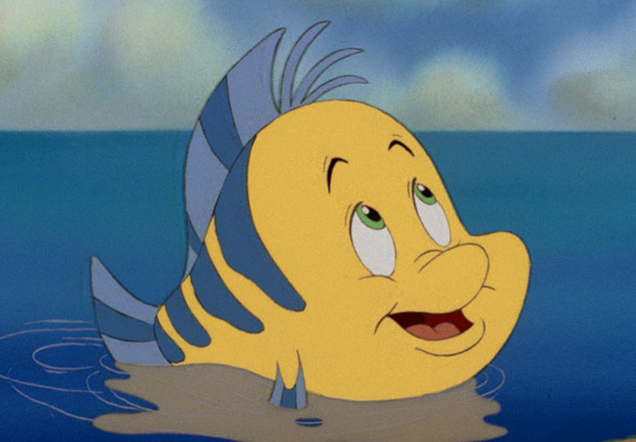 Cute animated character fish with yellow and blue stripes, smiling above water.