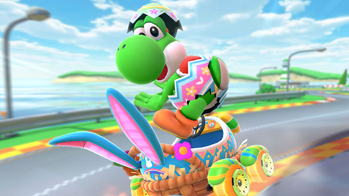 Cute animated character driving a colorful cart on a sunny road, wearing a festive outfit with an egg pattern.