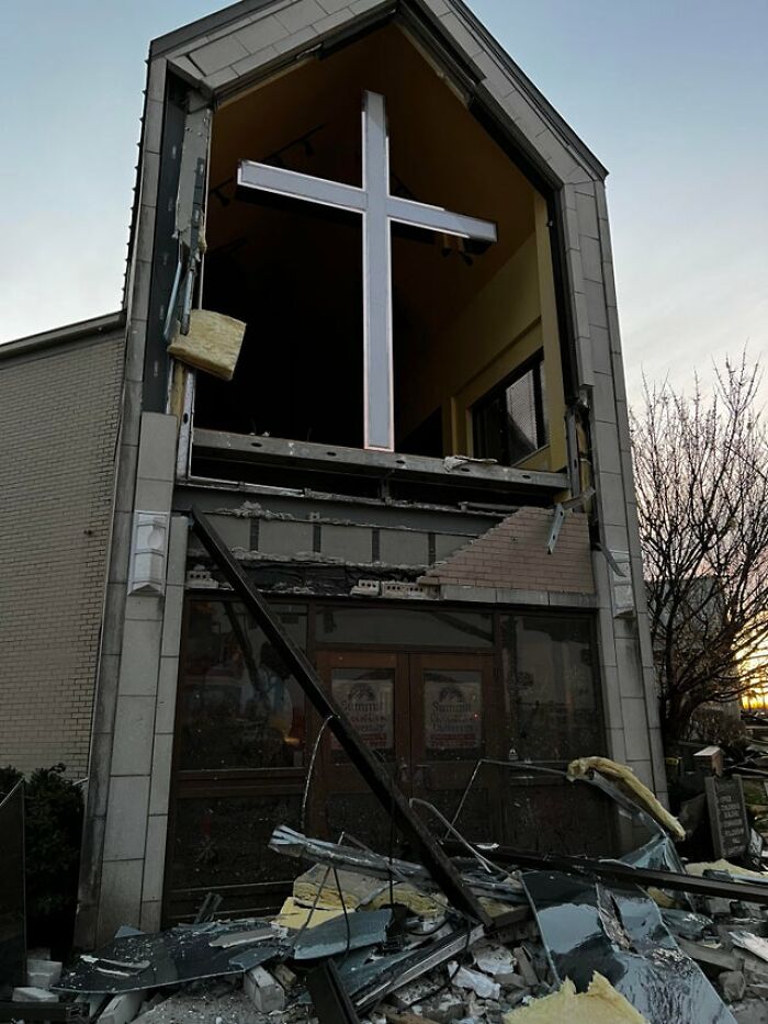 Damaged church exterior with rubble and debris after Mayfield tornado aftermath during sunset. Damaged church exterior with rubble and debris after Mayfield tornado aftermath during sunset.