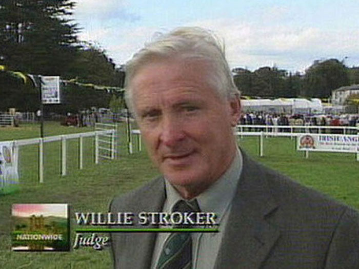 Man in a suit and tie named Willie Stroker at an outdoor event, related to dumbest names people have encountered.