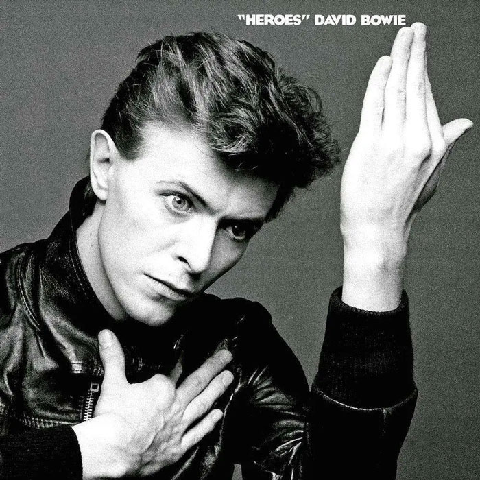 Iconic album cover featuring a person in a black jacket with a hand gesture, embodying classic music art style.