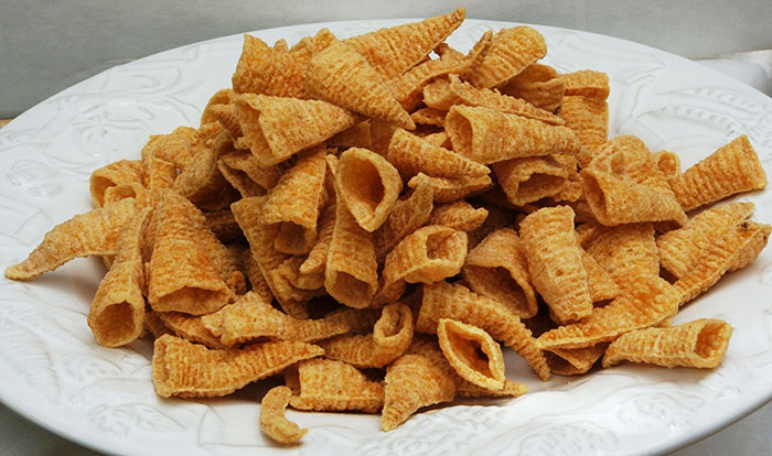 Nostalgic 90s foods: A plate of crispy cone-shaped snacks, reminiscent of popular 90s treats.