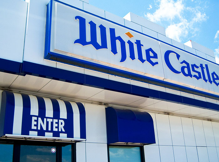 White Castle fast food restaurant exterior showing entrance under blue and white awning revealing job dark secrets.