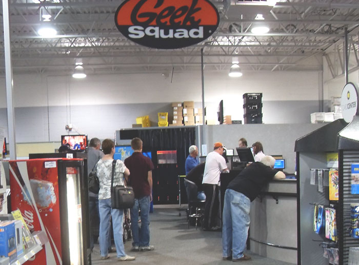 Customers waiting and employees working at a Geek Squad service center revealing dark secrets about their jobs.