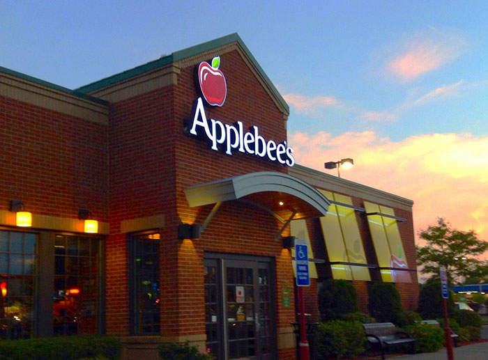 Applebee's restaurant exterior at dusk, symbolizing dark secrets revealed by employees about their jobs.