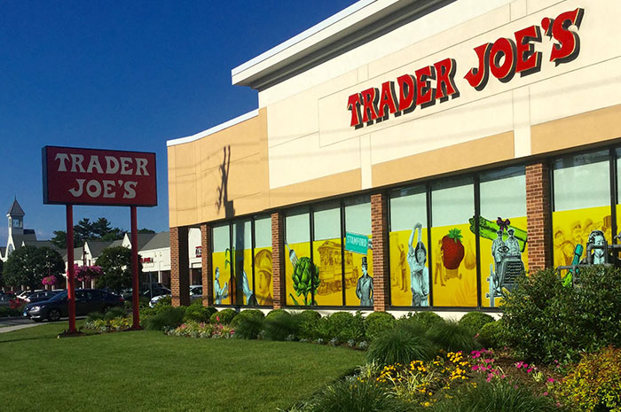 Trader Joe’s storefront on a sunny day with colorful window art, illustrating dark secrets about jobs not commonly known.