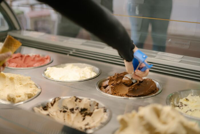 Person scooping chocolate ice cream in a shop, illustrating dates that took a weird and disturbing wrong turn.