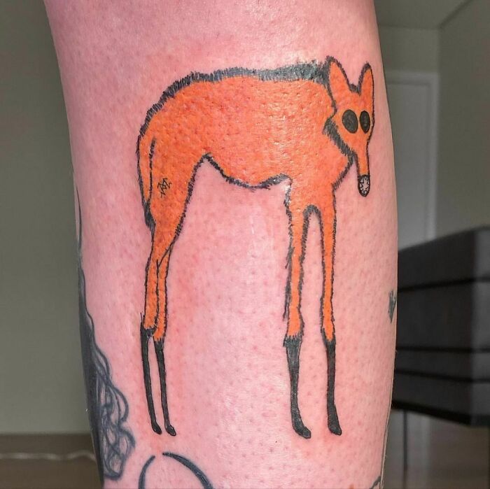 Tattoo of an abstract deer by a renowned artist famous for unique designs despite inability to draw.