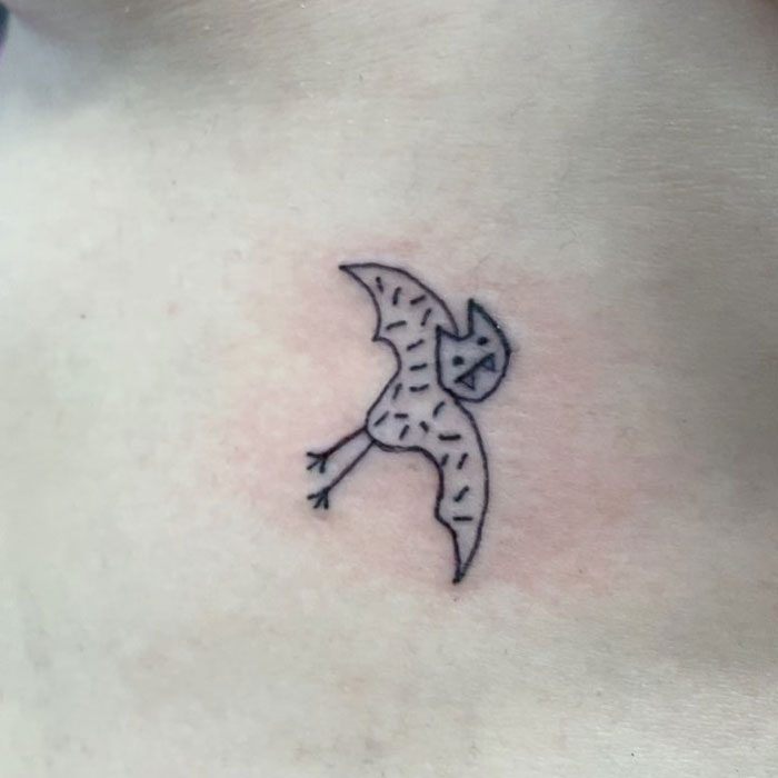 Simple line tattoo of an abstract bird design by a tattoo artist known for unique, imperfect drawings.