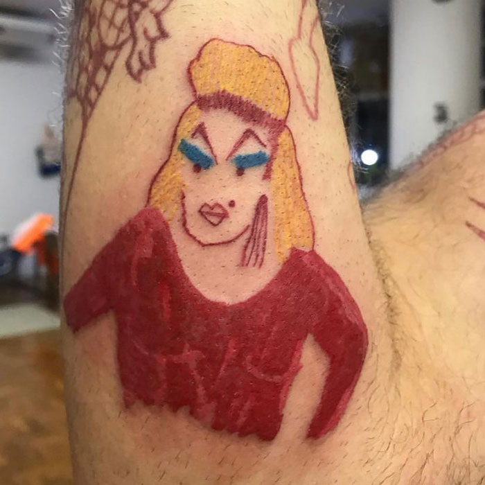 Tattoo of a cartoonish figure with bold colors, highlighting a unique tattoo artist's popular design style.