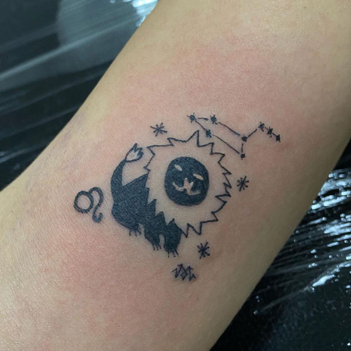 Abstract tattoo design of a lion and stars by tattoo artist known for unique, imperfect style.