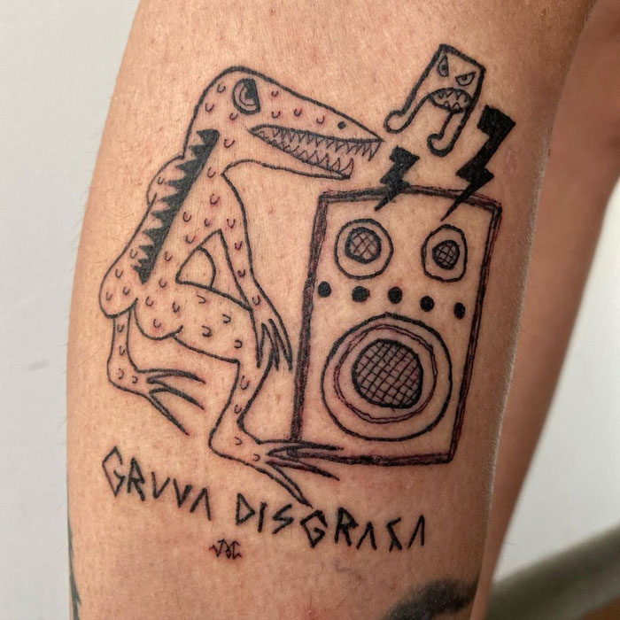 Unique tattoo design featuring a simplistic dinosaur and speaker on skin.