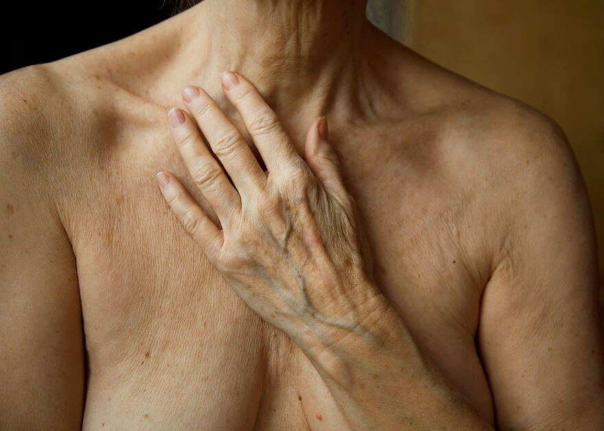 Close-up of an older woman’s hand on her chest, showcasing natural beauty captured by photographers around the world.