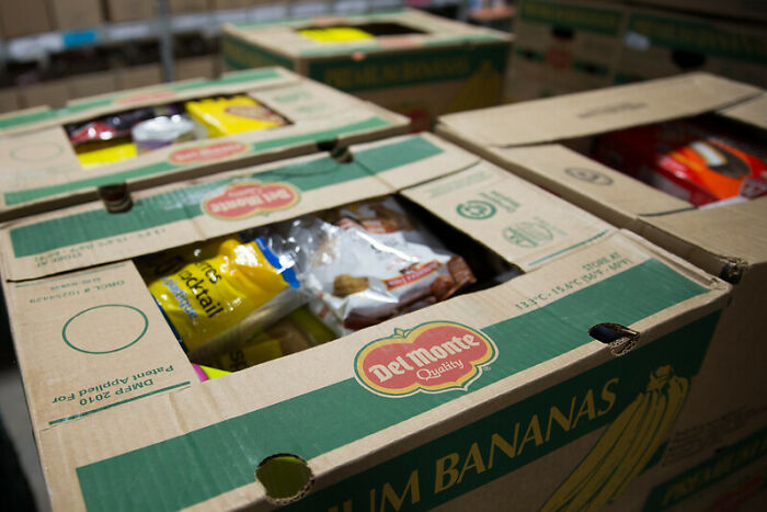 Cardboard boxes filled with groceries, highlighting the hidden secrets parents may keep oblivious to their children.