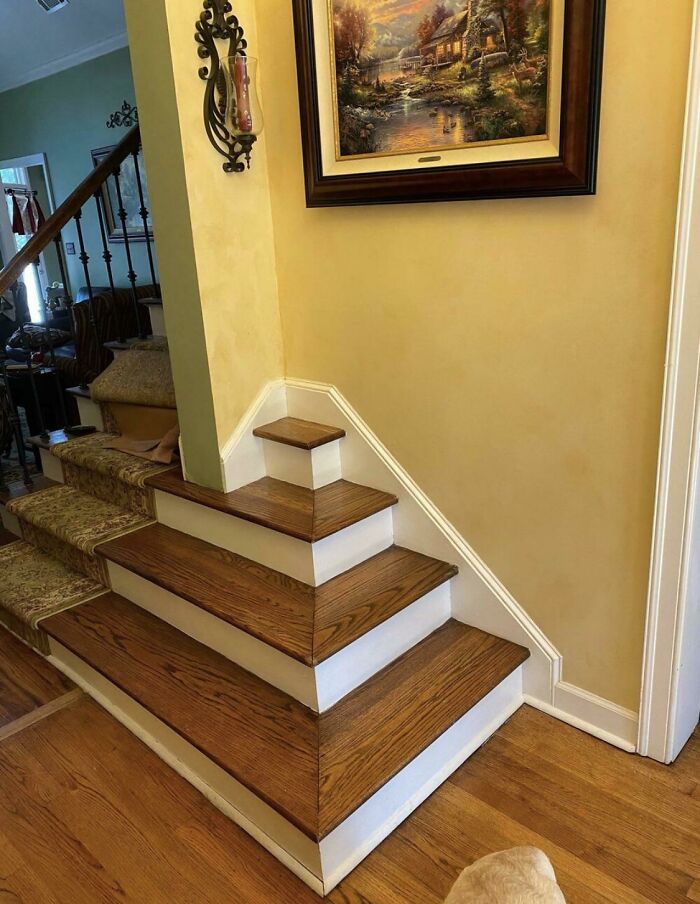 Unusual staircase design with an awkward, decorative mini-step, highlighting questionable interior choices.