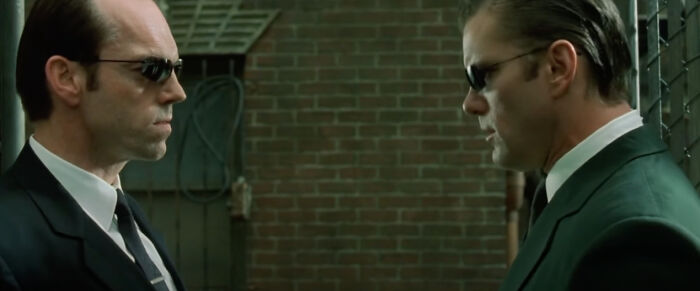 The Matrix Reloaded (2003) - In The Matrix Universe An Agent's Suit Is Slightly Green, But As Agent Smith Has Evolved He Now Has A Black Suit