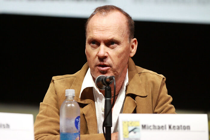 Actor Michael Keaton speaking at a panel, exemplifying actors who revived their career with a single role.