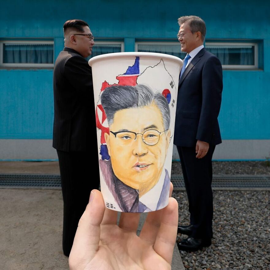Hand holding a paper cup with detailed illustrations of a man's face, highlighting unique art on paper cups.