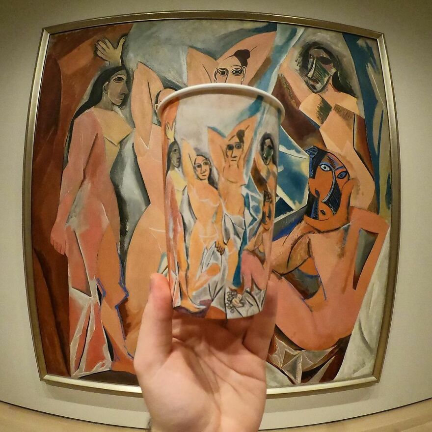 Hand holding a paper cup with detailed illustrations inspired by famous art, highlighting creative paper cup drawings.