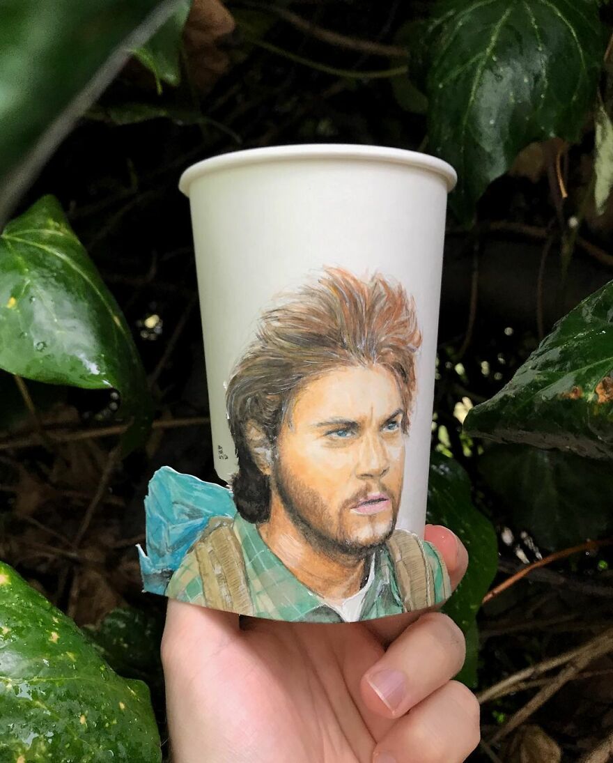 Paper cup with a detailed hand-drawn illustration of a man, showcasing unique art on paper cups during world travel.