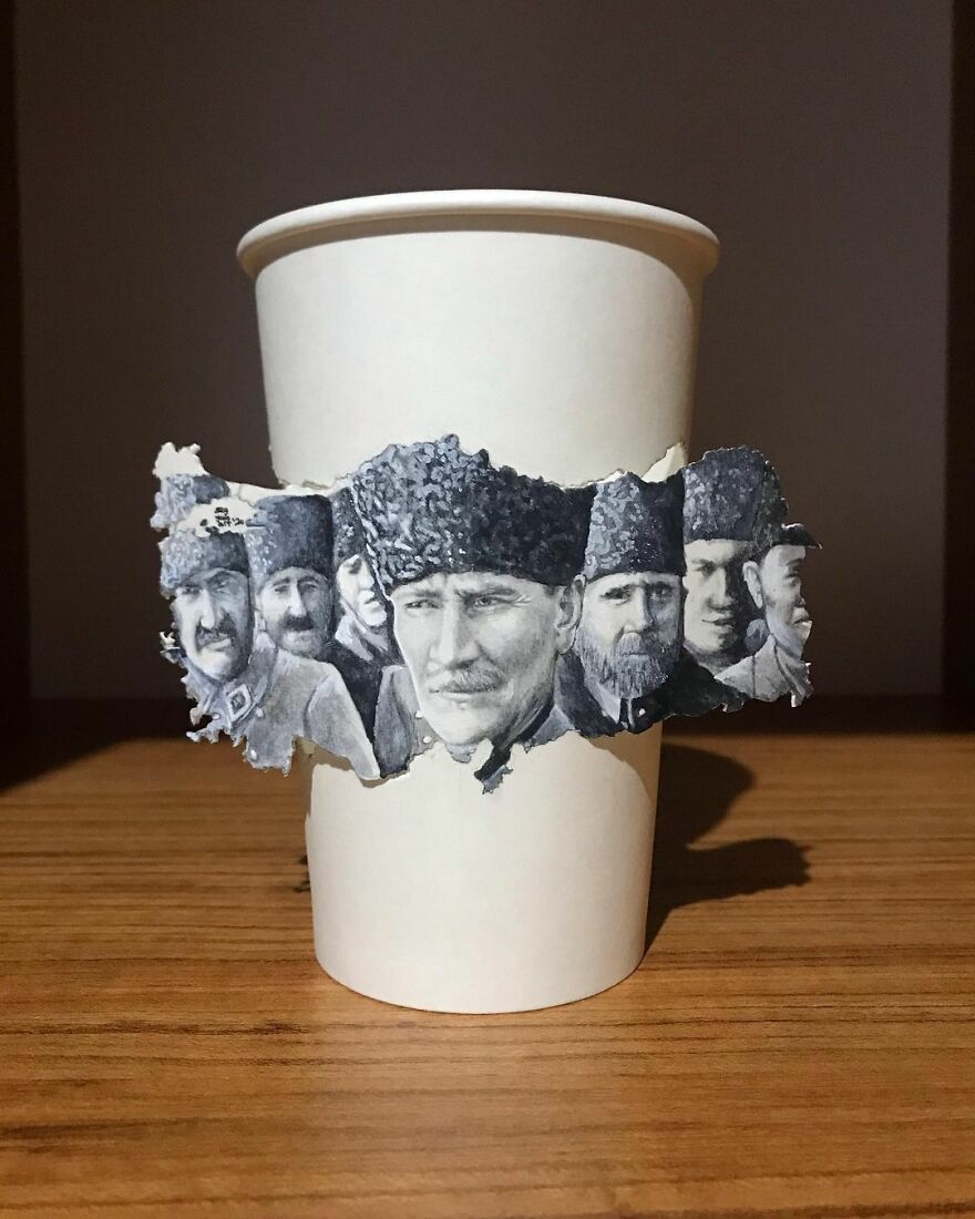 Paper cup with detailed illustrations of men in traditional hats drawn by an artist while traveling the world.