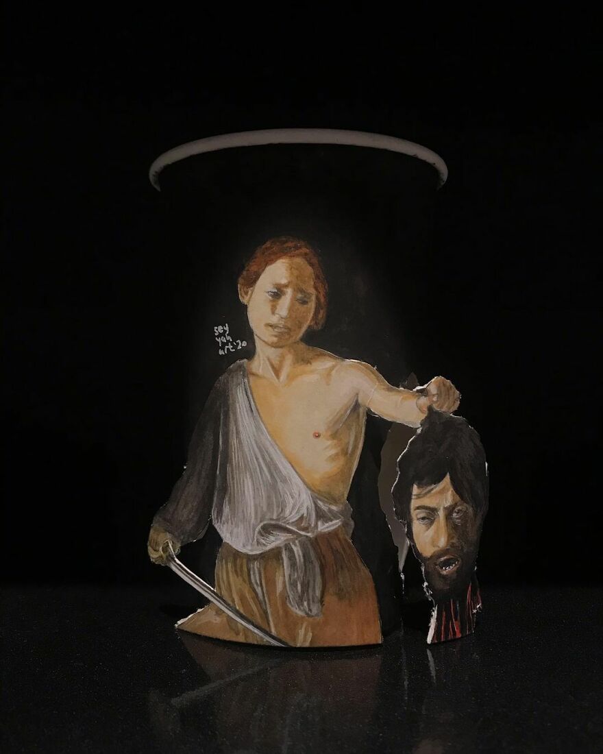 Paper cup illustration showing a detailed drawing of a classical figure holding a severed head, part of travel art series.
