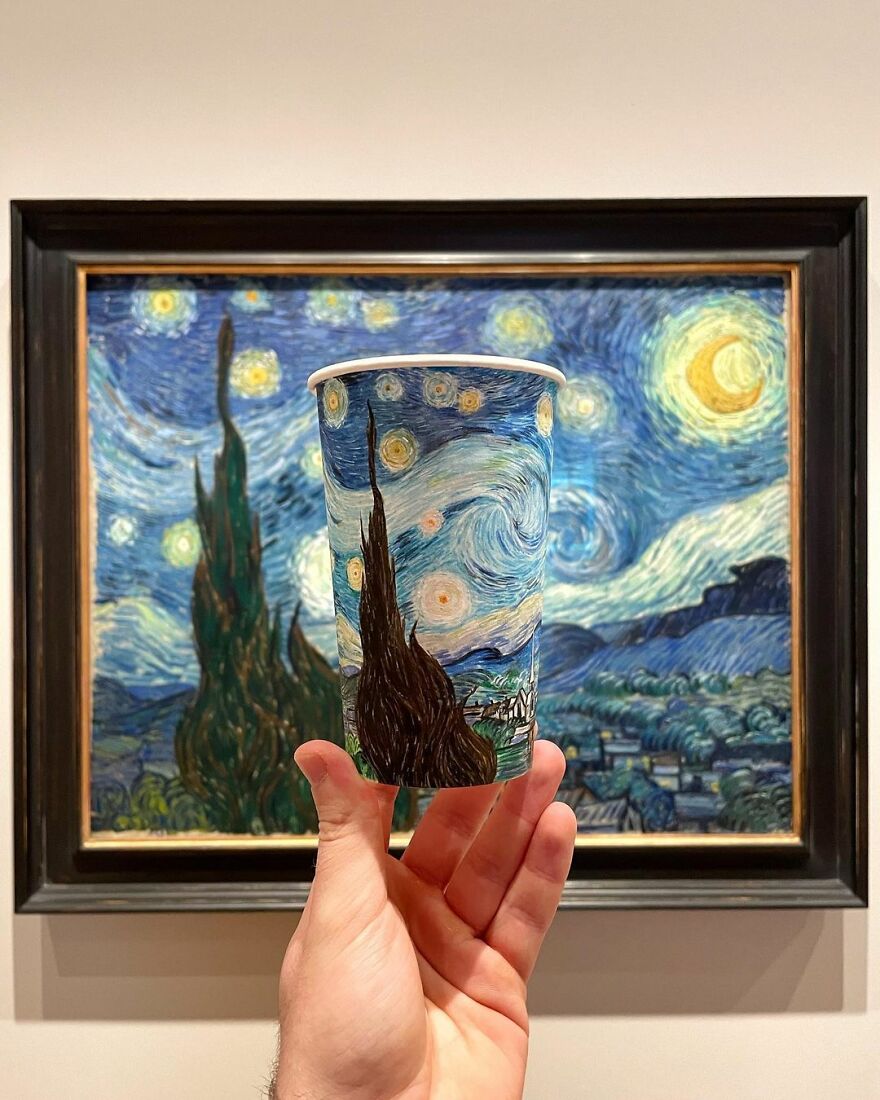 Hand holding a paper cup with a detailed illustration inspired by Van Gogh's starry night painting.