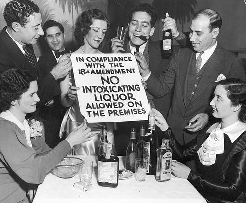 On This Day In 1920, The Prohibition Act Begins. With The Passing Of The 18th Amendment, Alcohol Was No Longer Allowed To Be Sold, Transported, Or Produced In The United States. This Resulted In An Increase In Organized Crime, Bootlegging, And Worsened Drinking Habits. Eventually In 1933, The 21st Amendment Repealed The 18th Amendment.