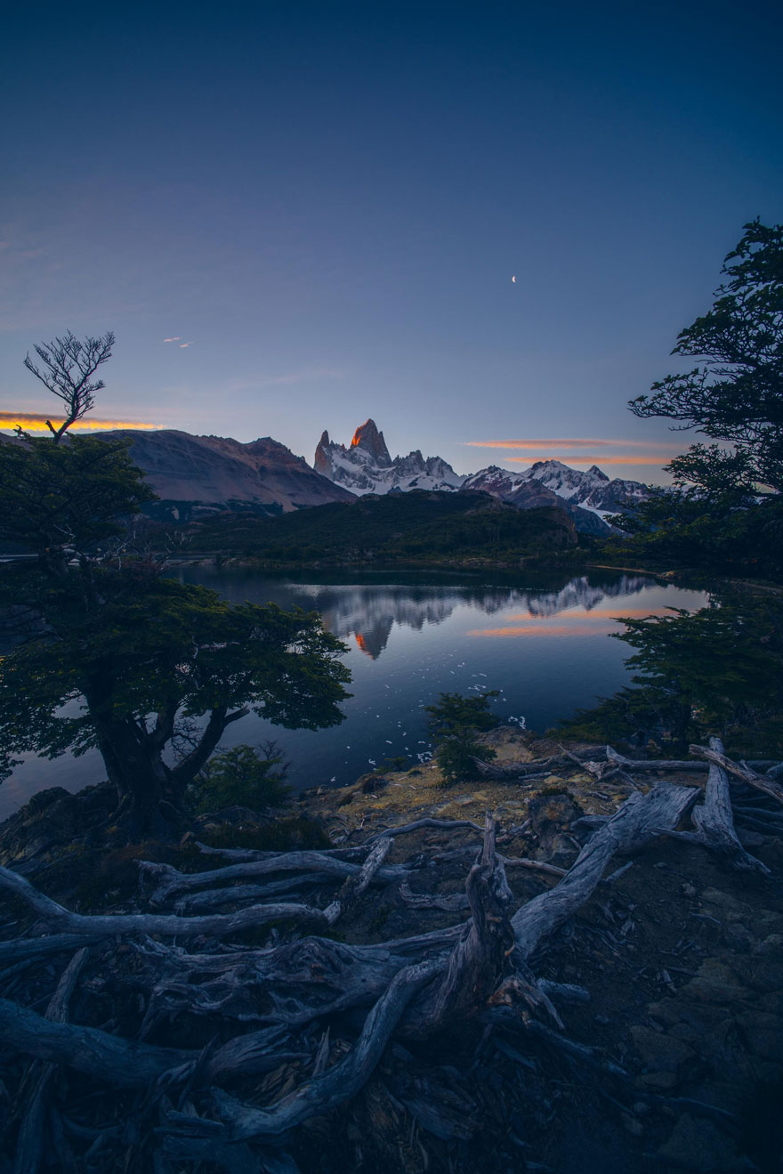 Stunning mountain scenery reflected in a tranquil lake at dusk.