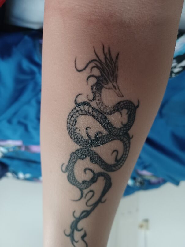 Impressive new tattoo of a detailed dragon design on an arm.