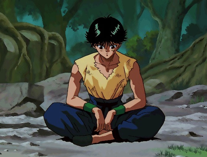 Yusuke sitting in lotus pose on the ground
