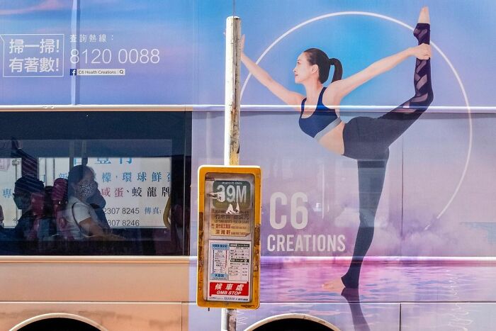 Bus advertisement showing a dancer in perfect balance, a lucky accident captured by photographer Edas Wong.
