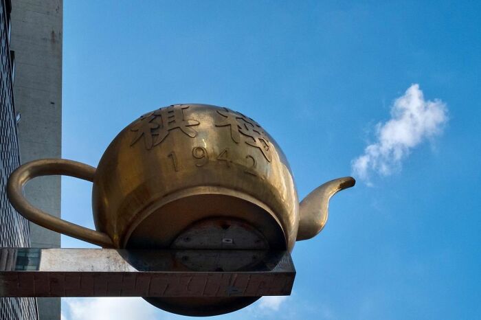 Bronze teapot sculpture with steam resembling a cloud, illustrating lucky accidents captured by photographer Edas Wong.