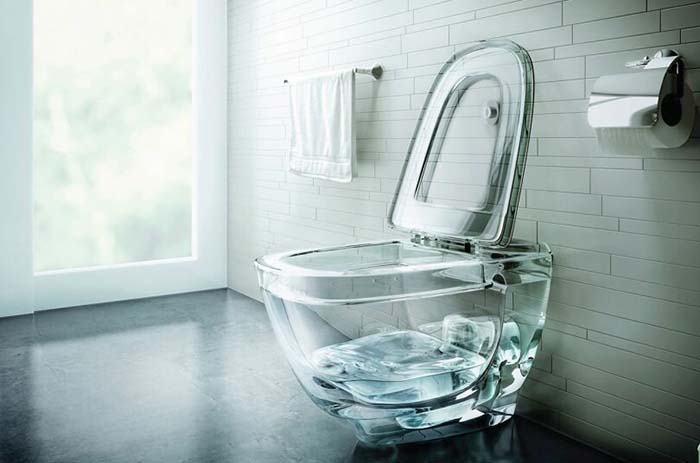 Transparent glass toilet showcasing unusual home interior design choices.