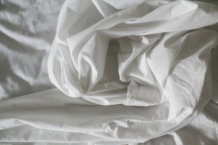 Crumpled white bed sheets symbolizing reality TV and how fake it all was for participants.