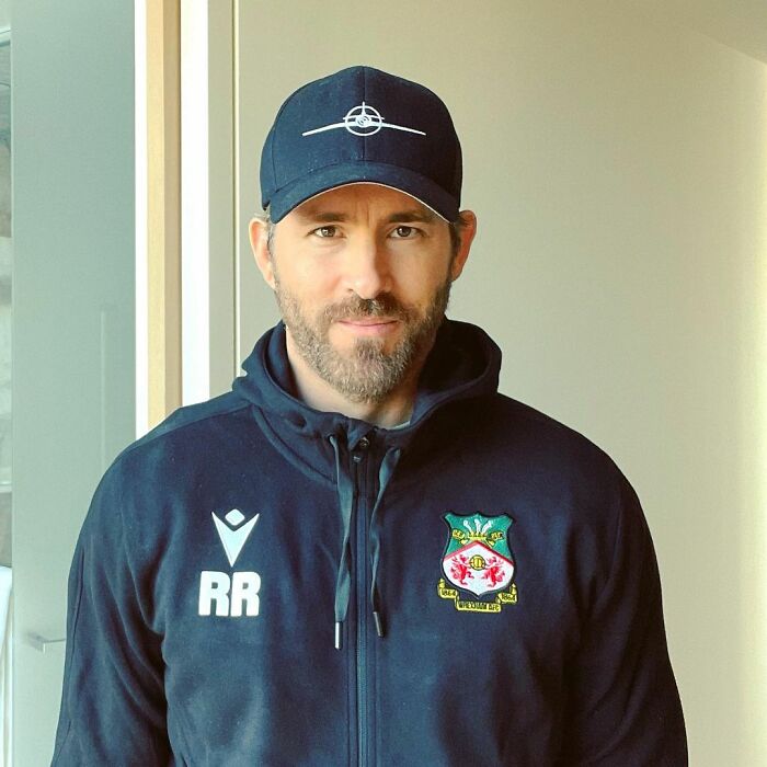 Ryan Reynolds wearing a cap and sports jacket with initials RR, representing actors who revived their career with a single role.