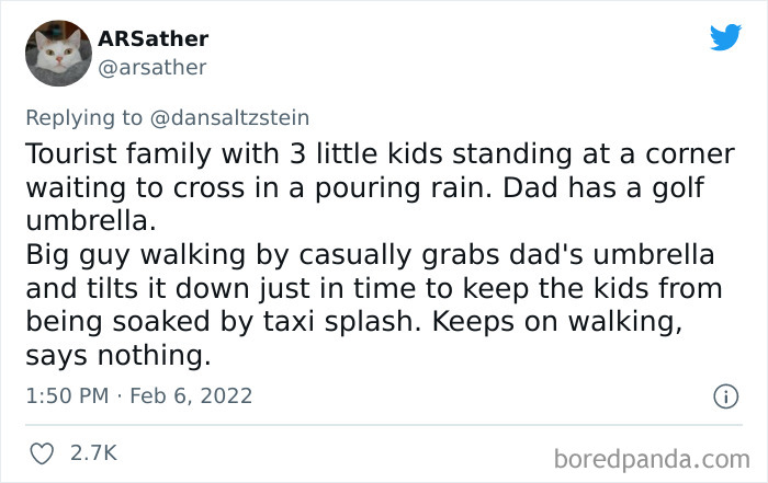 Tweet about a wholesome New Yorker helping a tourist family protect kids from taxi splash in pouring rain.