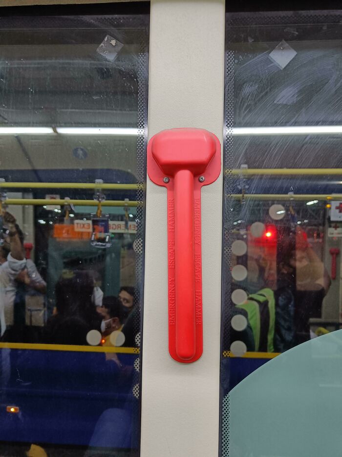 This Emergency Escape Hammer Is Placed Behind A Plastic Cover Sealed With Screws. No There Is No Emergency Screwdriver Anywhere