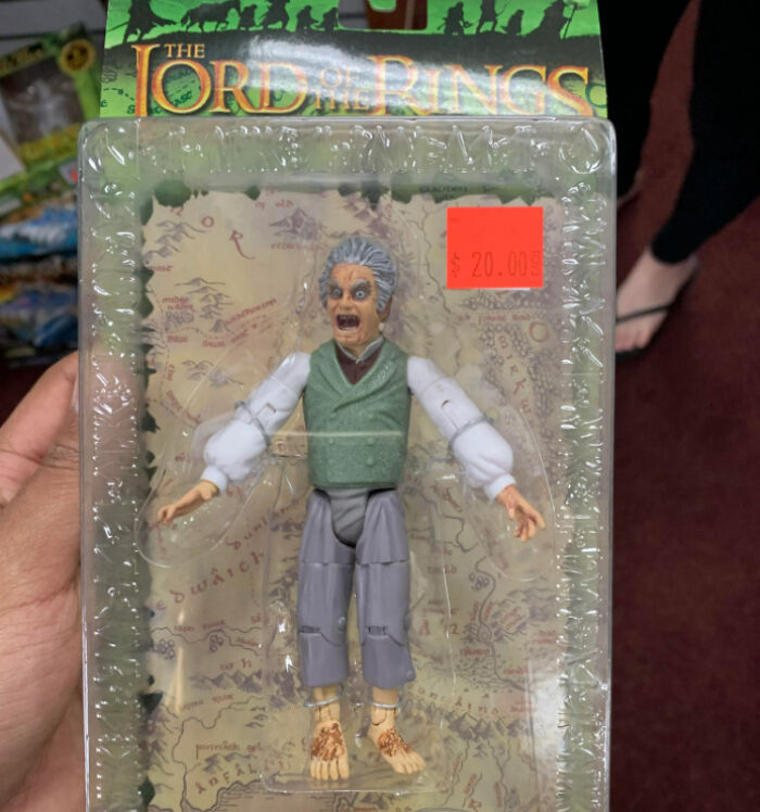 Creepy Lord of the Rings toy figure with exaggerated facial expression in original packaging and a $20 price tag.