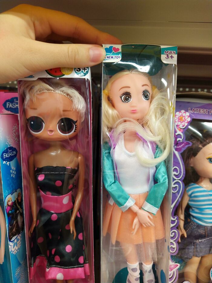 Two creepy dolls with large eyes and unusual facial expressions in retail packaging, creepy toys causing nightmares.