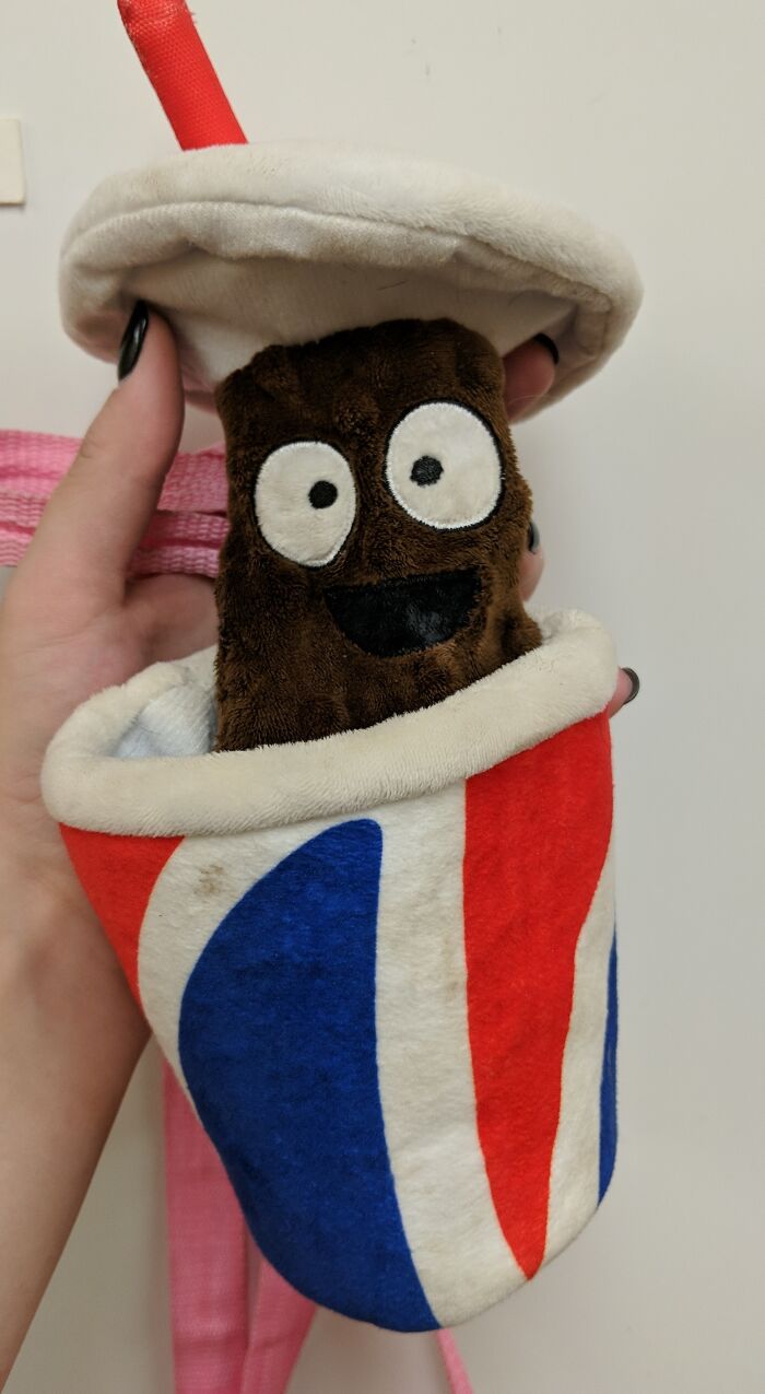 Plush toy with wide eyes wrapped in a red, white, and blue cup, one of the creepy toys that will give us nightmares.