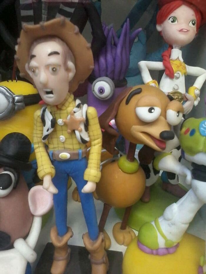 Creepy toy figures from popular animated movies with distorted and unsettling facial expressions on display.