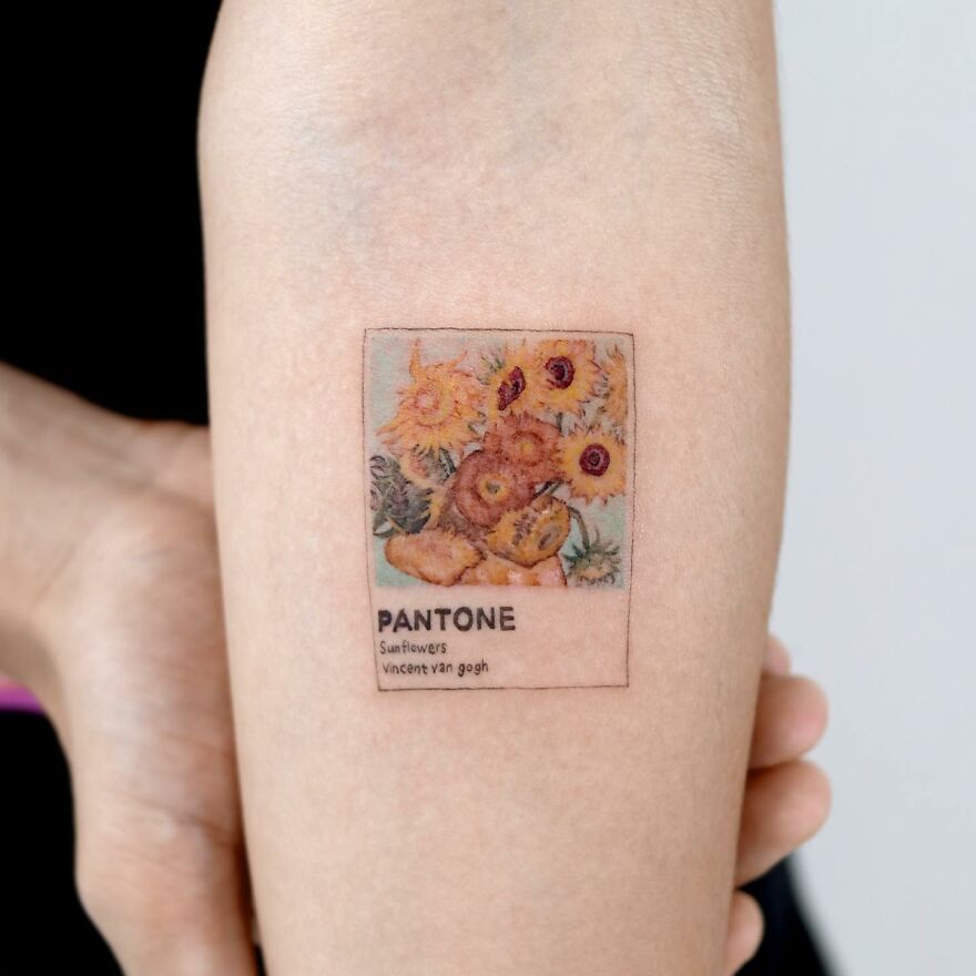 Tattoo resembling a painting of Van Gogh's sunflowers in Pantone style on forearm.