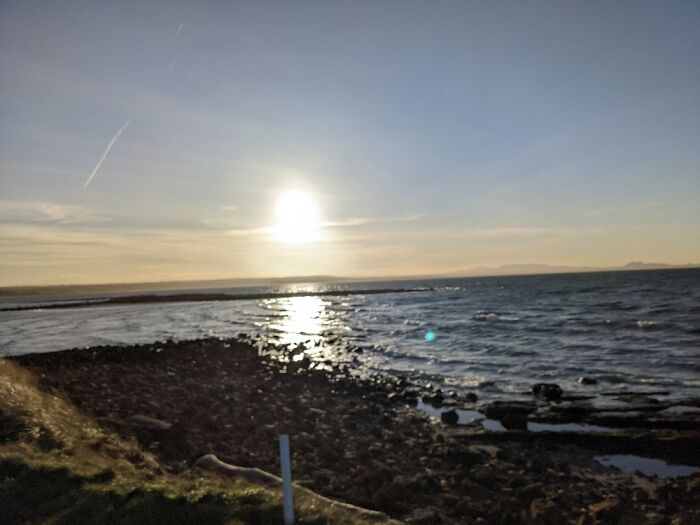A Small Beach Next To A Golf Course In Scotland