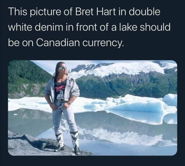 Man in denim by a lake, surrounded by mountains, embodies Canadian stereotypes humor in a meme.