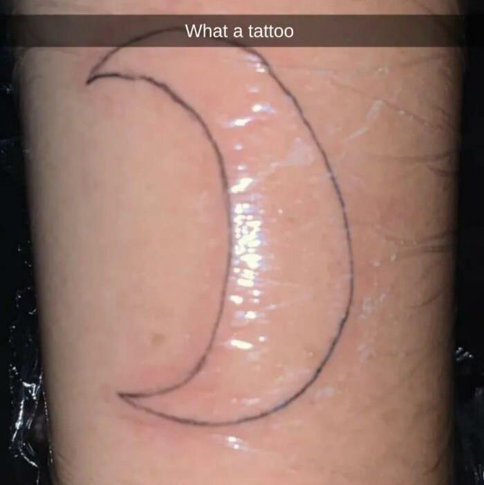 Poorly drawn crescent moon tattoo with text "What a tattoo" overlay.