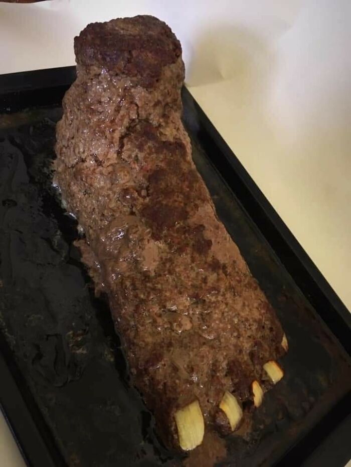 Cursed food shaped like a foot, made of meatloaf with garlic cloves as toenails.