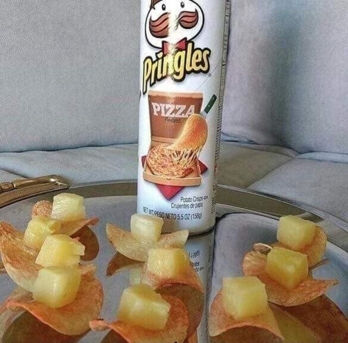 Pizza-flavored Pringles topped with pineapple chunks on a tray; example of cursed foods.