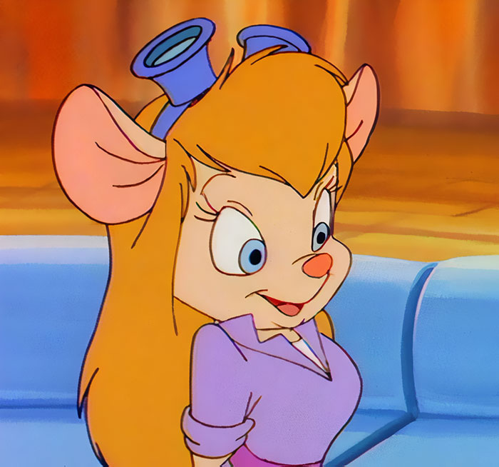 Cute animated character with large ears and blonde hair, smiling in a purple outfit.